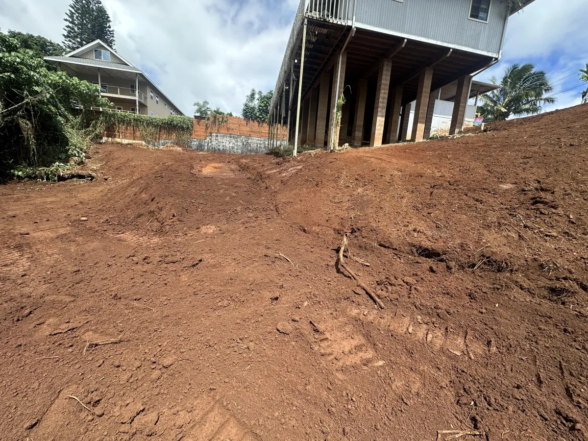 Residential site prep grading and root grubbing in Kauai red dirt clay