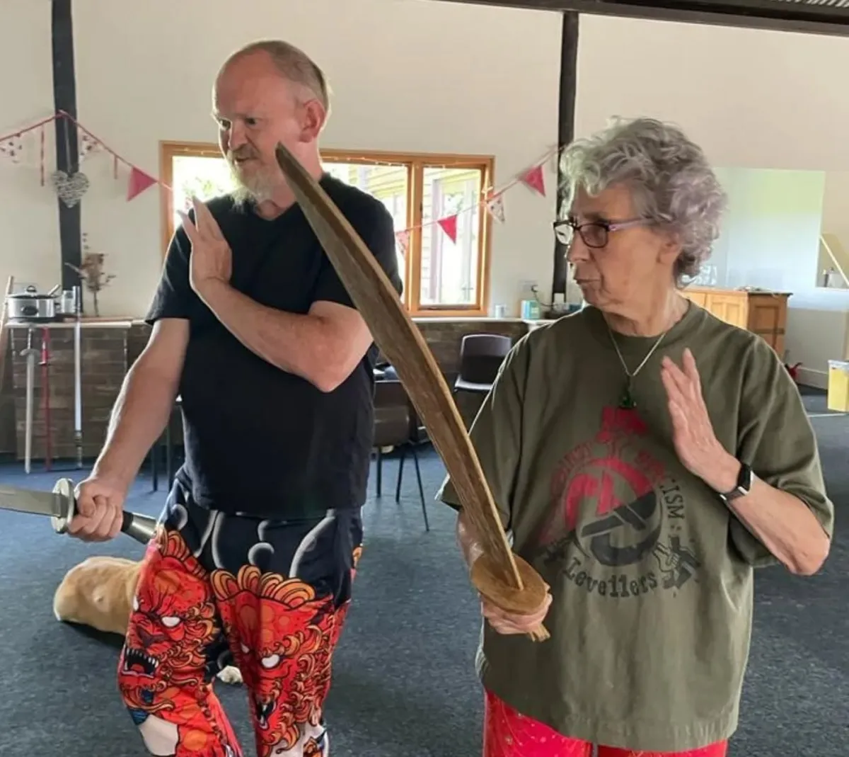 woman sitting on cliff overlooking mountains during daytime