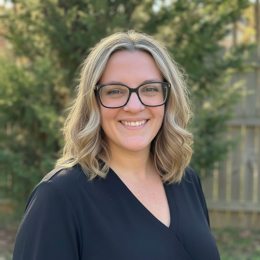 Professional woman with blonde hair and glasses