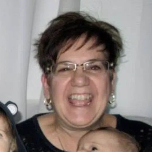 Middle-aged woman with short, dark hair and glasses