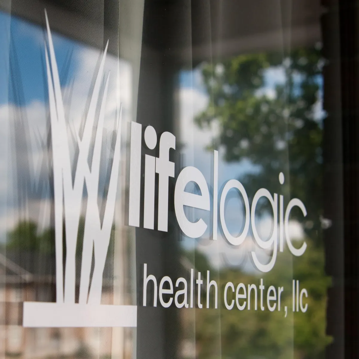 White vinyl of logo on glass door reading "LifeLogic Health Center, LLC"
