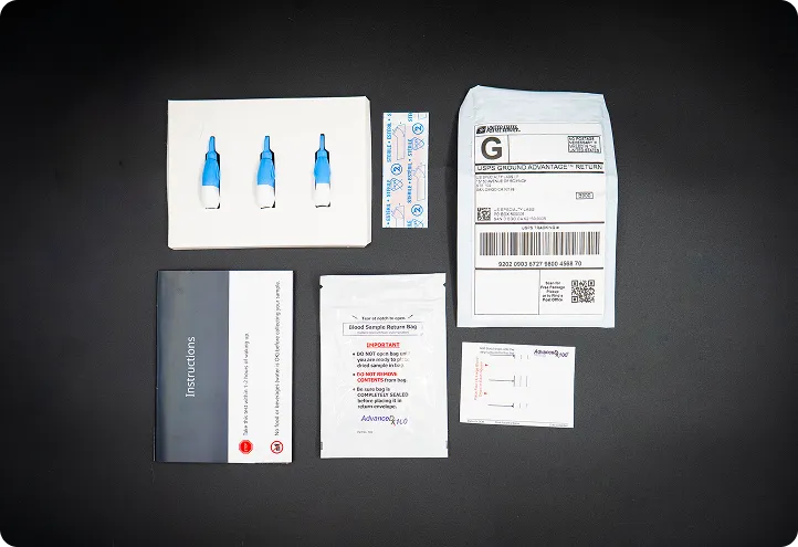 Contents of Gameday Men's Health testosterone test kit. Instruction manual, lancets, band-aids, alcohol wipe, prepaid mailer, and pouch.