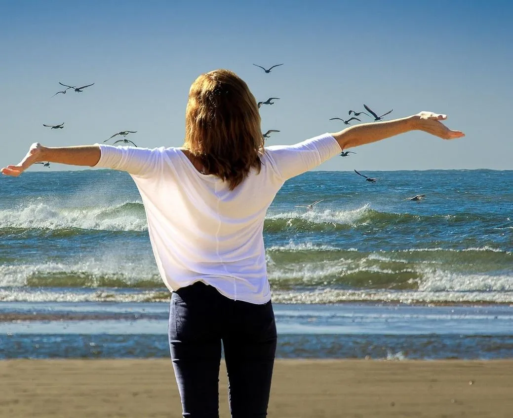 body of water near mountain during daytime