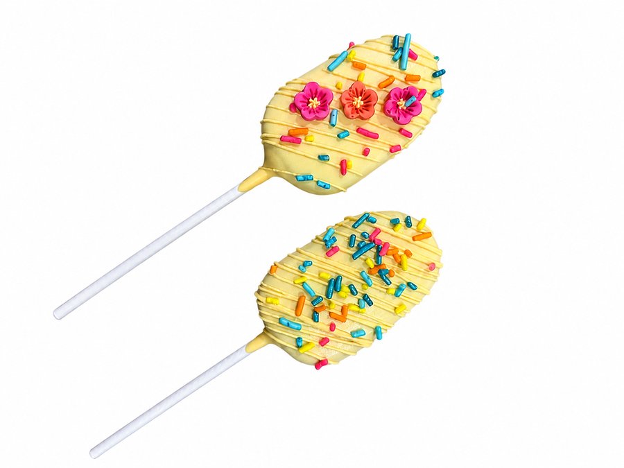 Yellow luau cakesicles with rainbow sprinkles and tropical flower fondant decorations