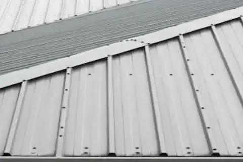 Standing seam metal roof panels on commercial building installed by Coon Rapids Commercial Roofing
