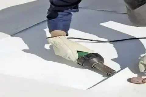 TPO white membrane seam heat welded by Coon Rapids Commercial Roofing technician on flat roof