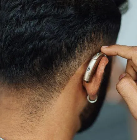 a man wears a hearing aid