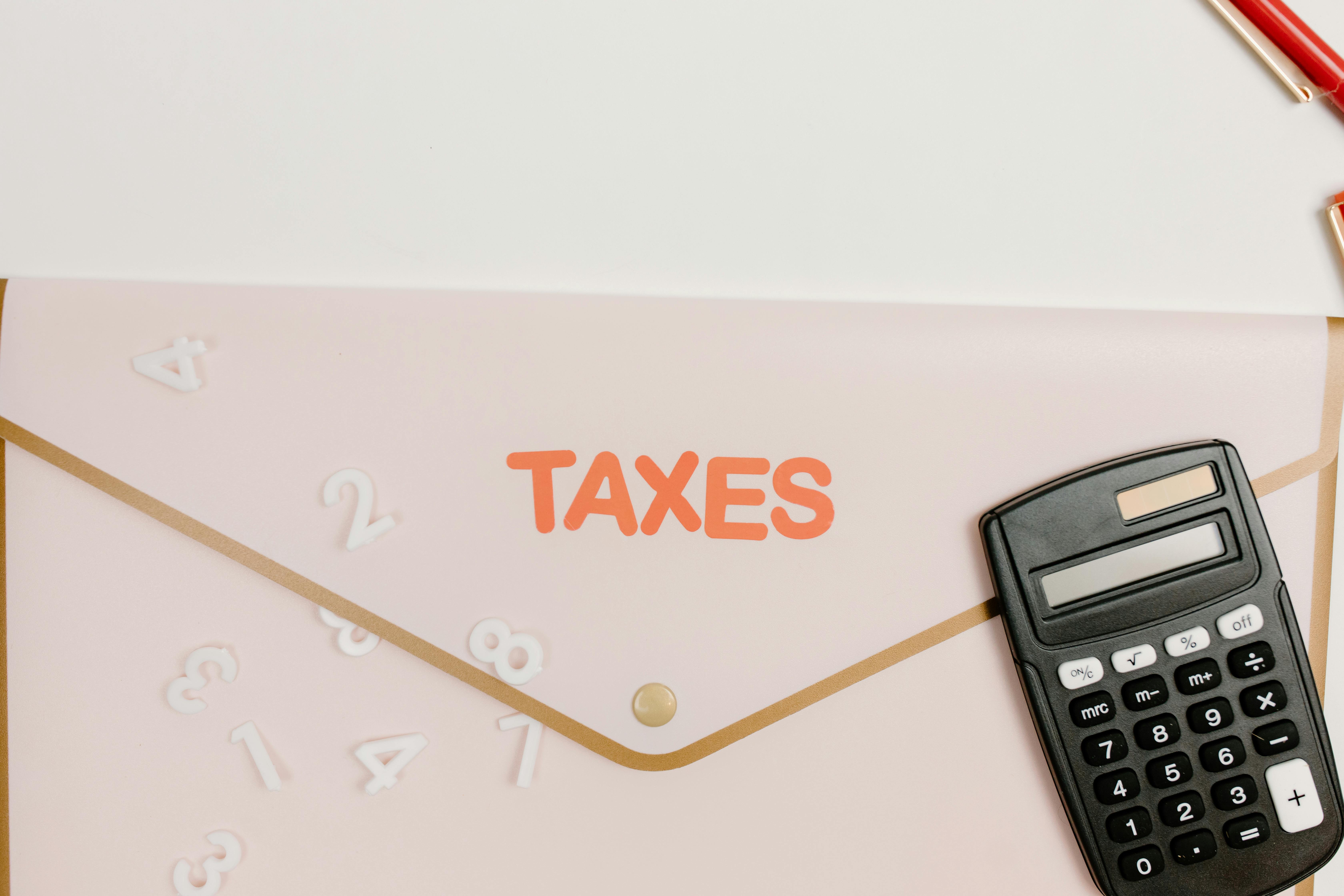 Calculator and pen on tax forms