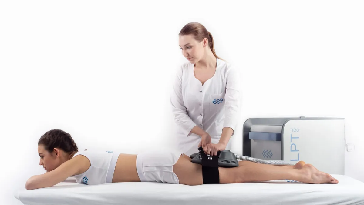 Woman receiving an Emsculpt Neo body contouring treatment on her abdomen