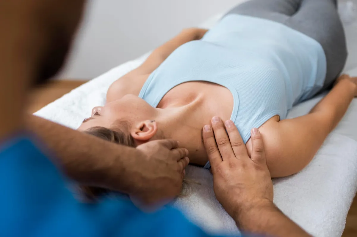 Chiropractor gently assessing a patient's neck and shoulders during a first chiropractic visit