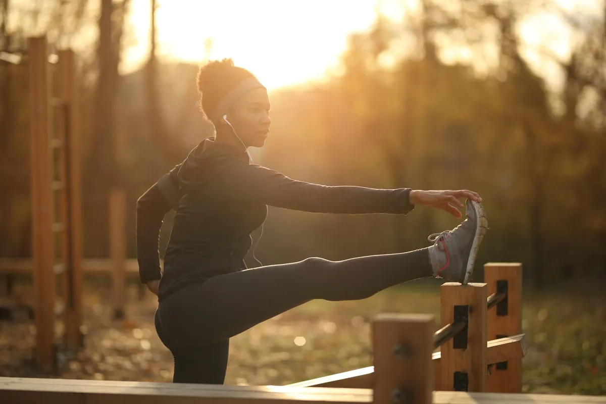Woman stretching outdoors as part of an everyday movement routine for back comfort