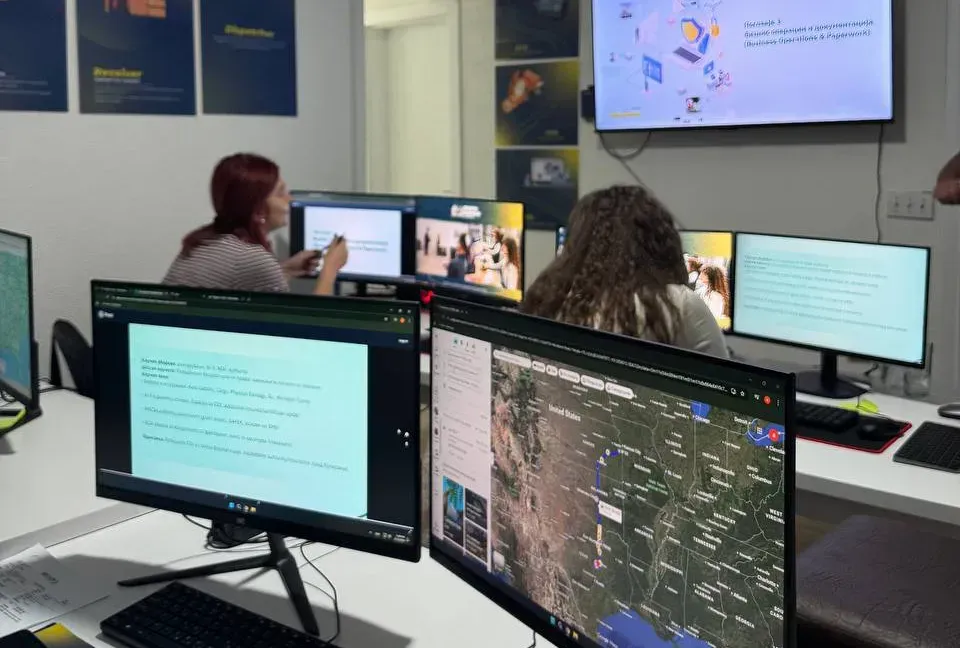 Students attending in-person dispatch training class with multiple computer screens and live instruction