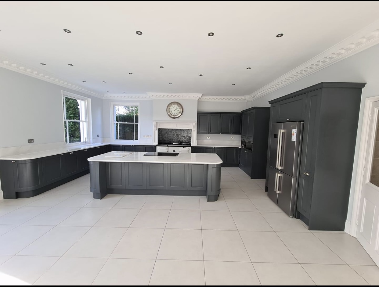 Modern German kitchen in Saltaire and also done in Halifax by Bradford Bespoke Kitchens featuring matte slab cabinetry, brown/gold fixtures and handlesless design
