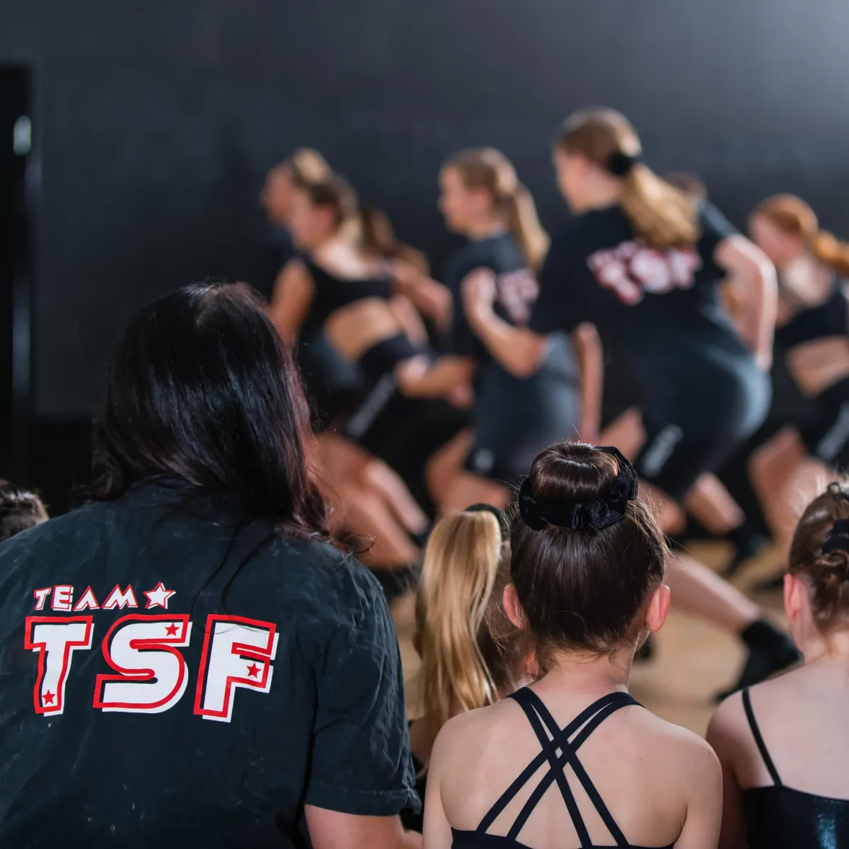 Students together with their Dance Instructor watching other students' rehearsal at The Star Factory Joondalup, where elite dance training and performance pathways inspire young dancers to shine.