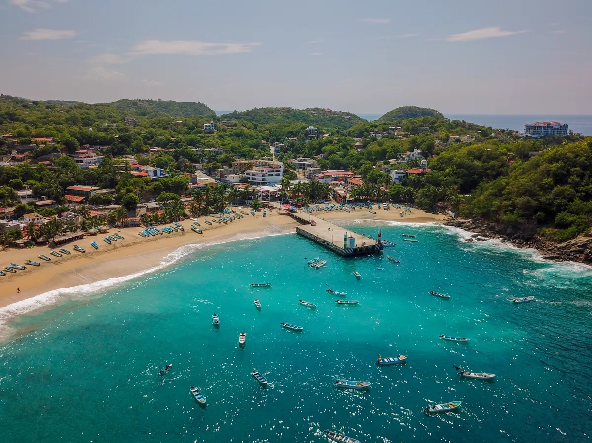 Dramatic coastal cliffs and Pacific surf break at Puerto Escondido