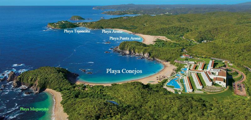 Aerial view of pristine Conejos Bay showing secluded beaches and cliffside private estates
