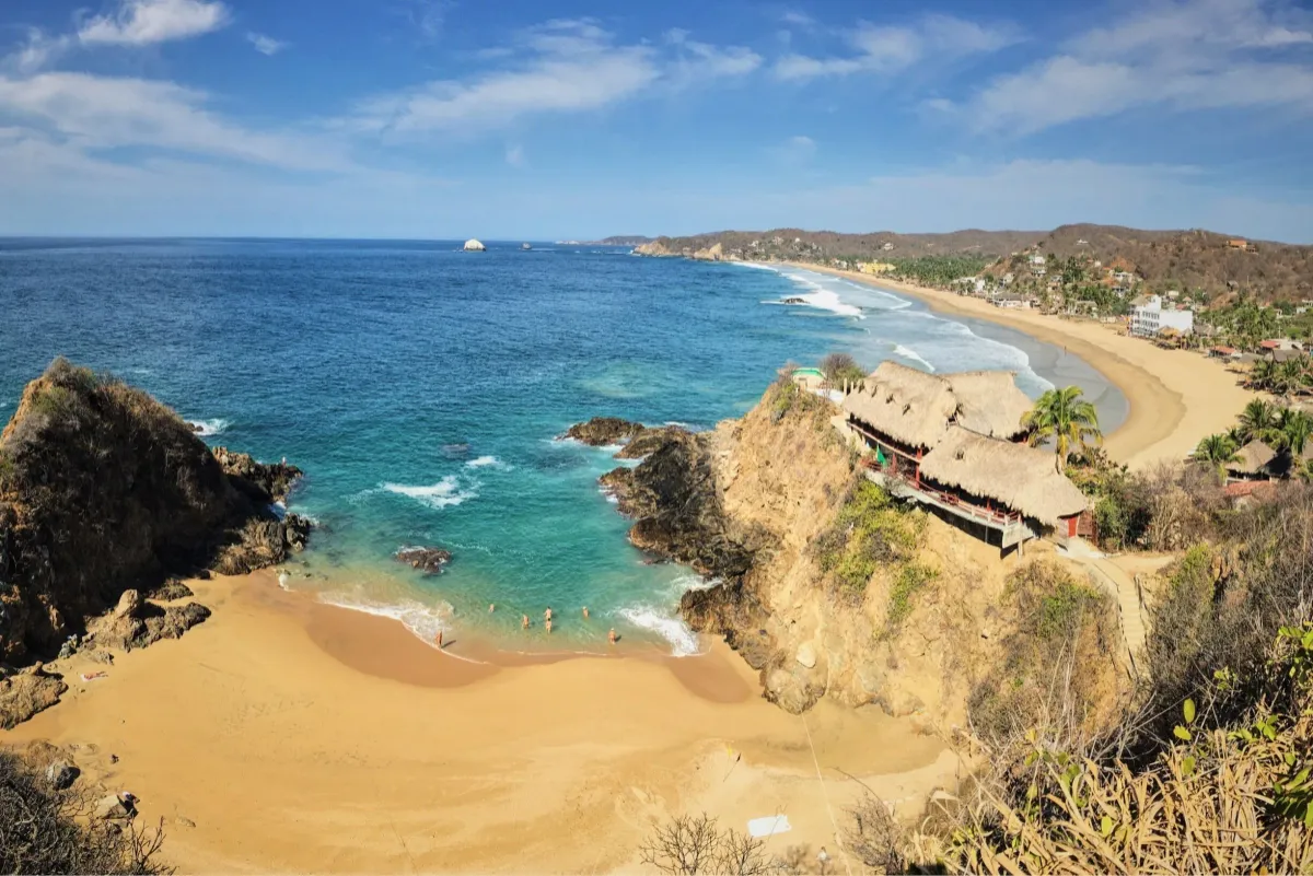 Zipolite expansive golden sands and ocean surf during warm evening light