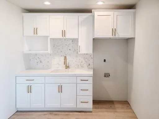 white kitchen cabinets with gold detail