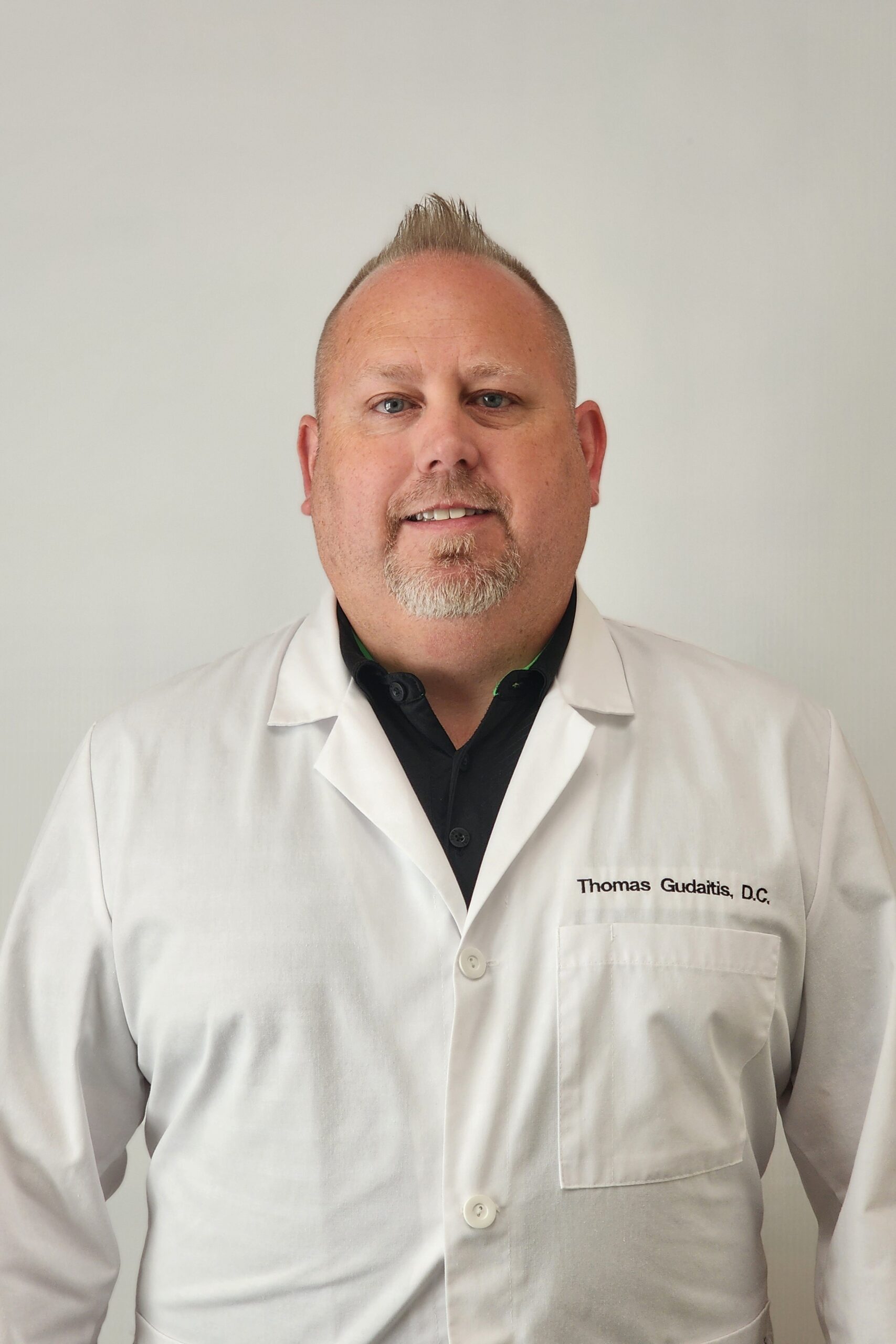 Dr. from AlignWell Chiropractic smiling in the clinic