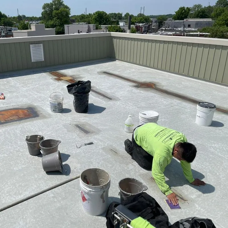 Fiberglass roofing contractor repairing commercial roof, ensuring lasting durability and protection.