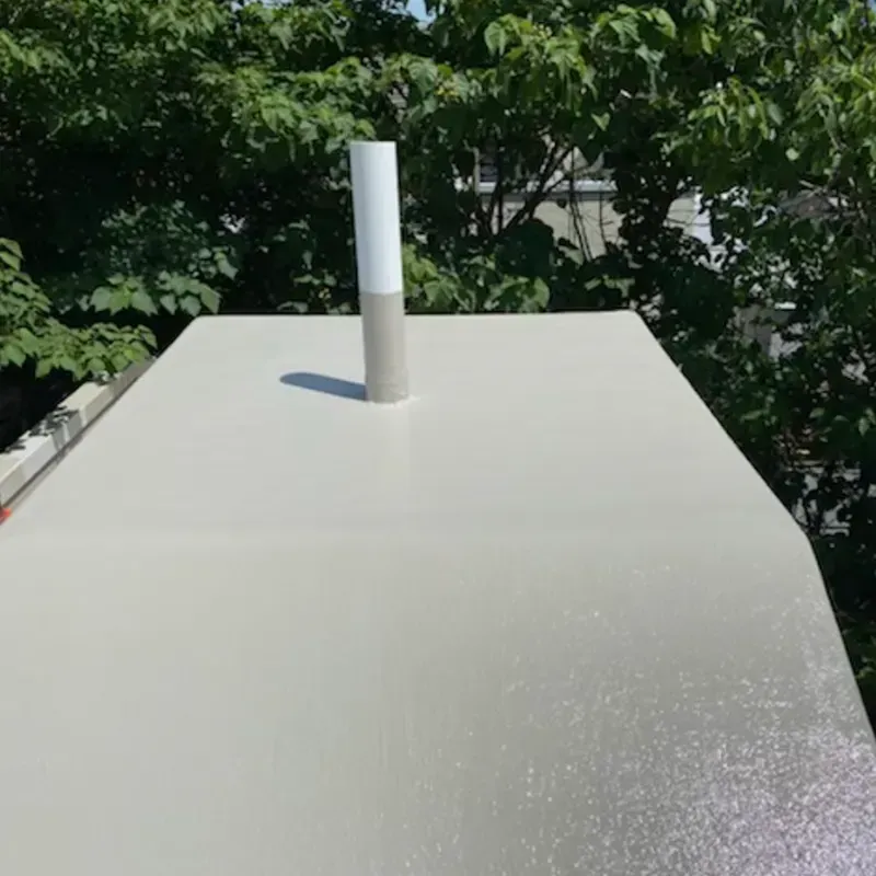Fiberglass roof repair and maintenance with a vent pipe on a commercial roof