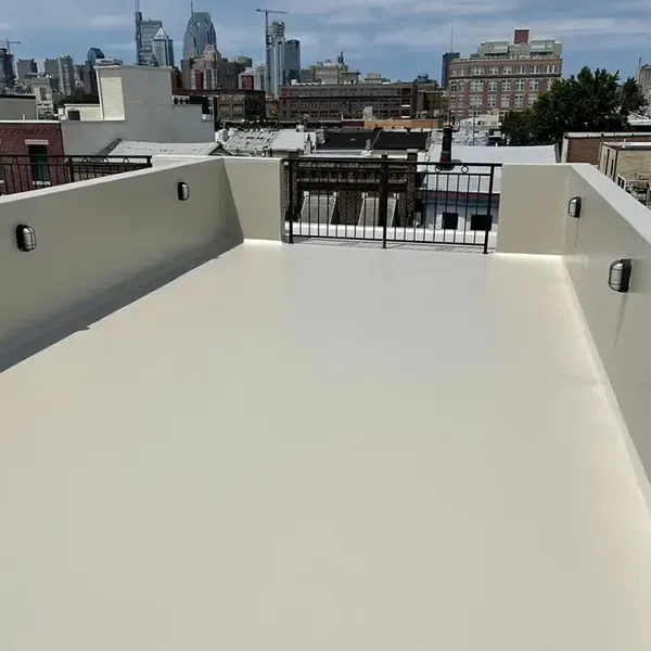 Fiberglass roofing installation in Upper Darby, PA with city skyline view.