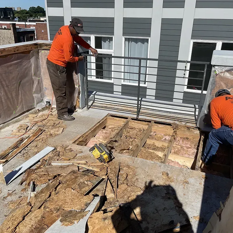Technicians performing fiberglass roof repair in Cherry Hill, PA