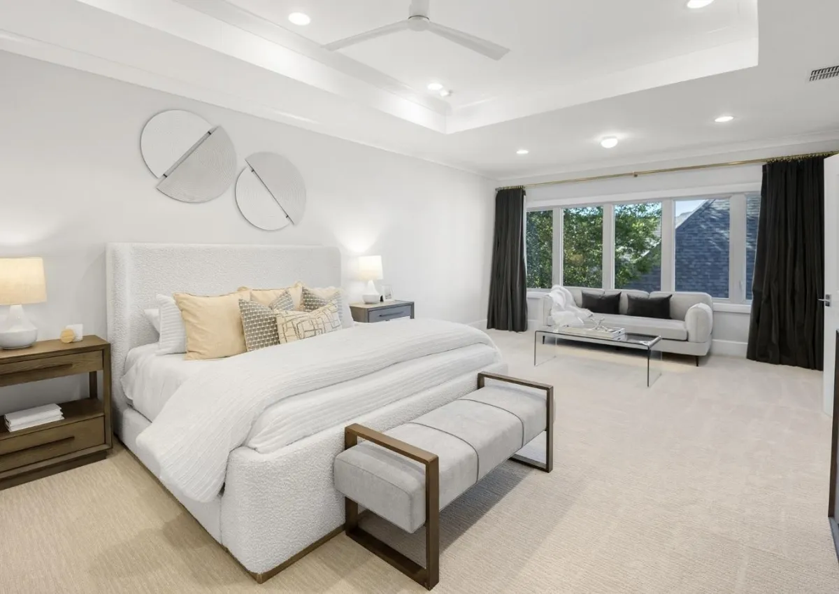 Spacious bright white primary bedroom with light-colored carpet and an oversized window, professionally staged by Model My Home to highlight spacious design and natural light—Dallas Fort Worth home staging experts.