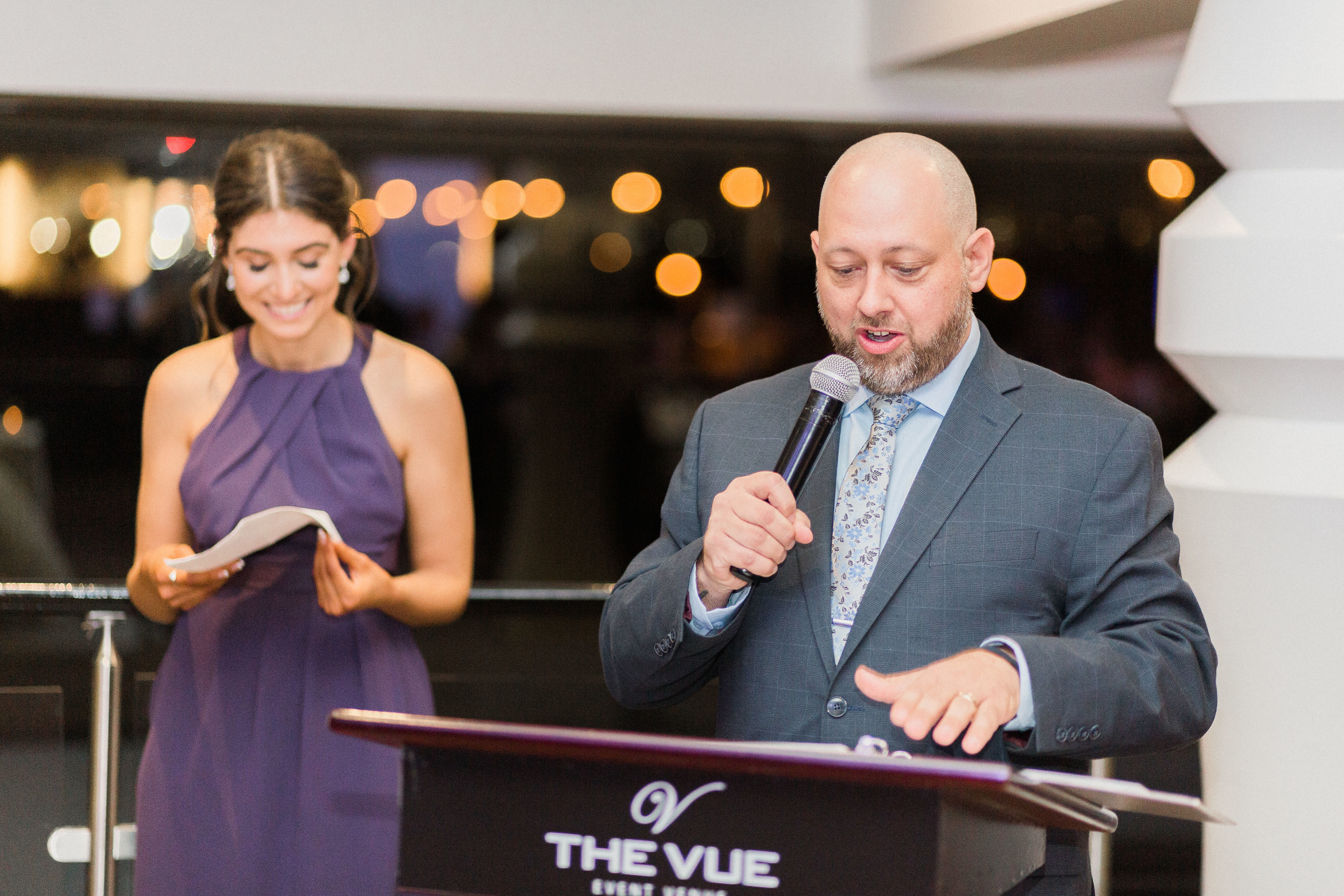 DJ Joe with a microphone during speeches at a wedding reception at The Vue, Etobicoke, ON