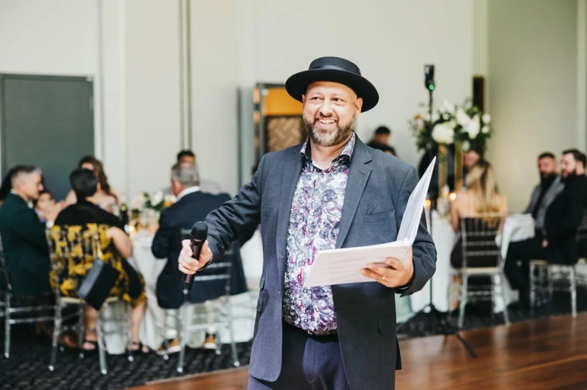 DJ Joe greeting wedding guests during a lively Southern Ontario wedding reception.