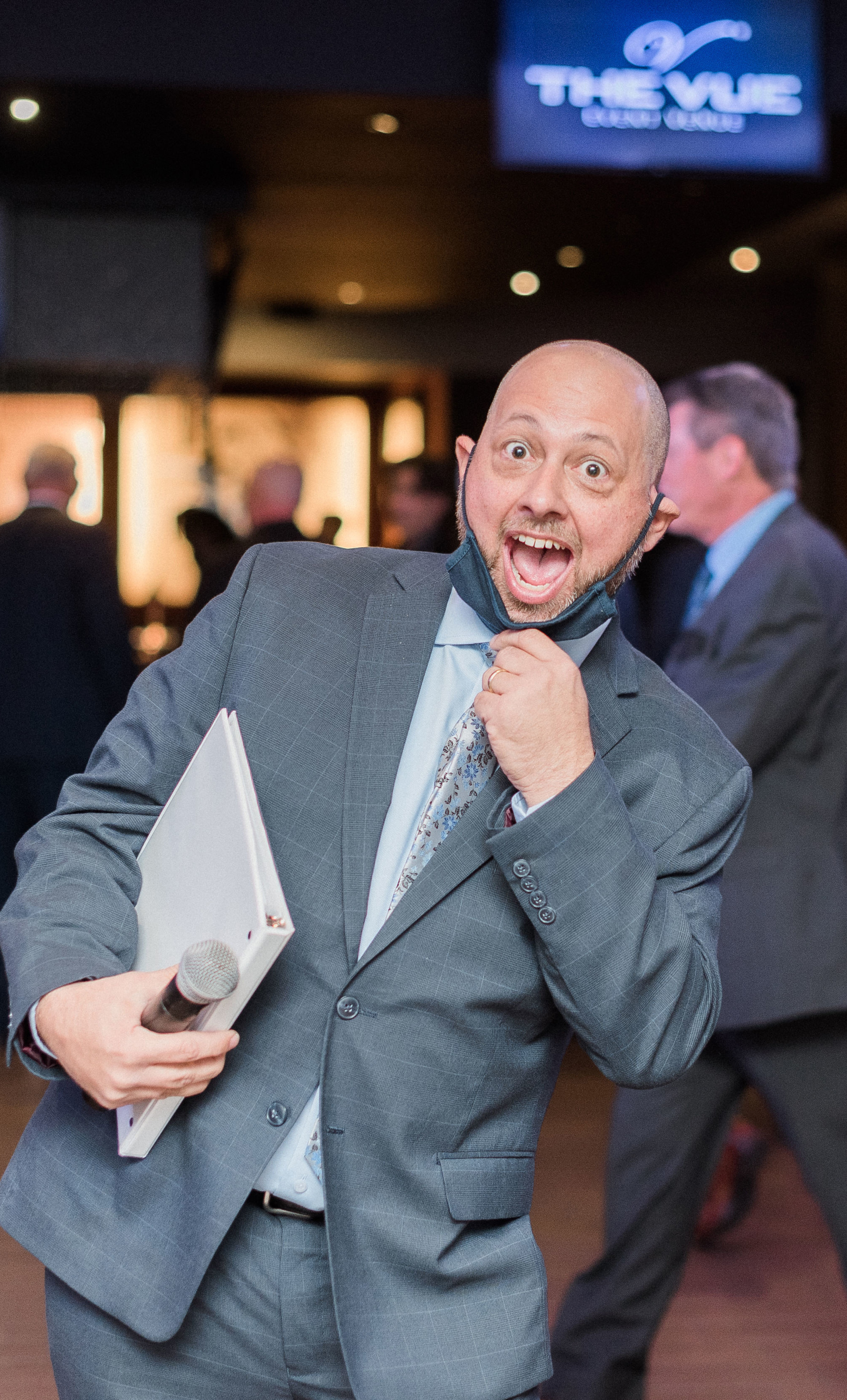     DJ Joe smiling and interacting with wedding guests during a reception.
