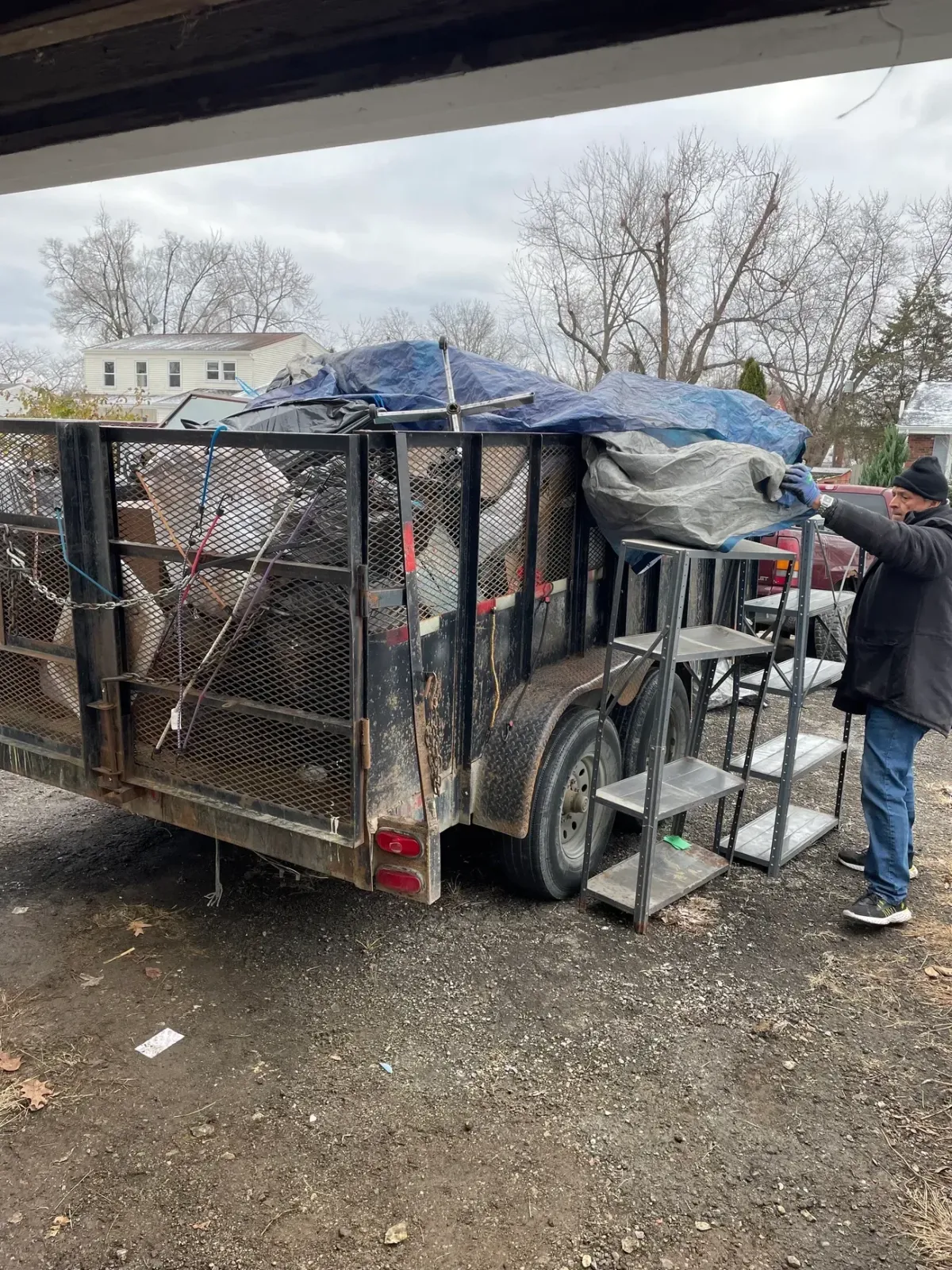Diverse group of volunteers holding trash bags by water