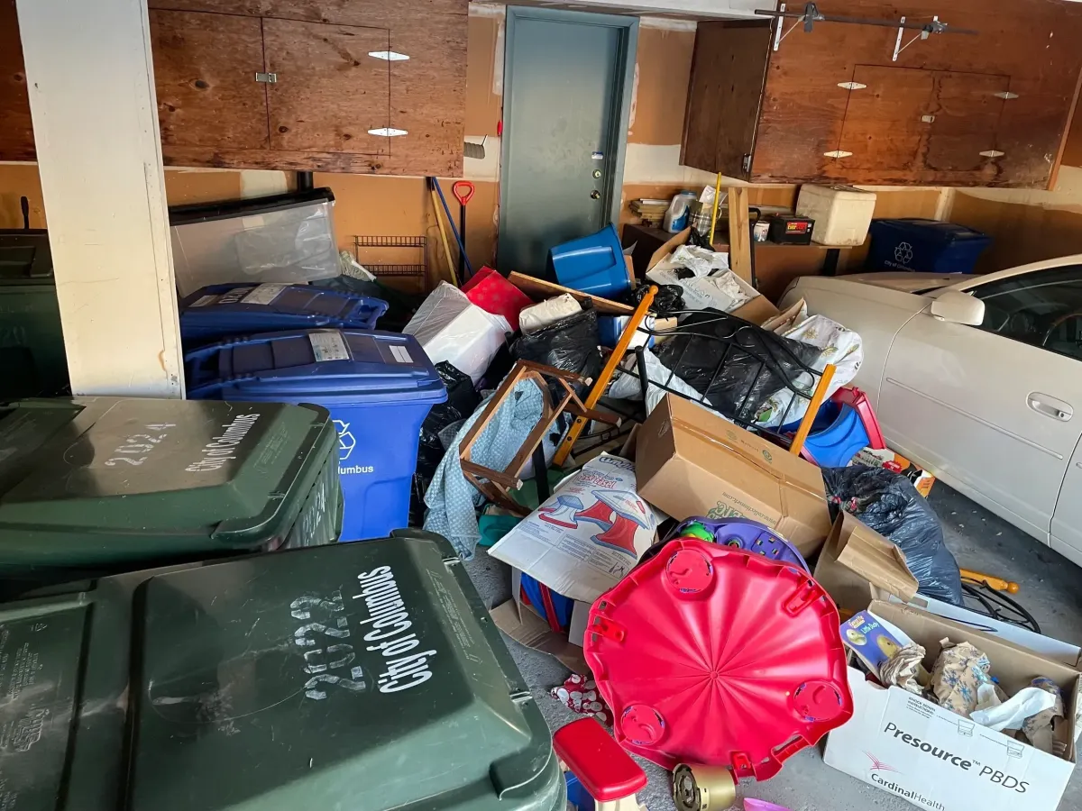 a pile of trash sitting next to a metal fence