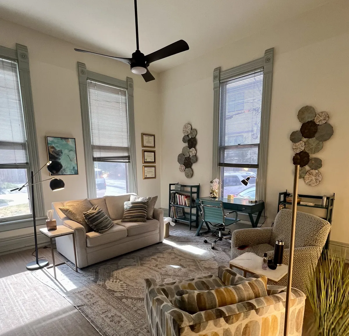 Attachment Services of Arkansas therapy room with sofa and tall windows
