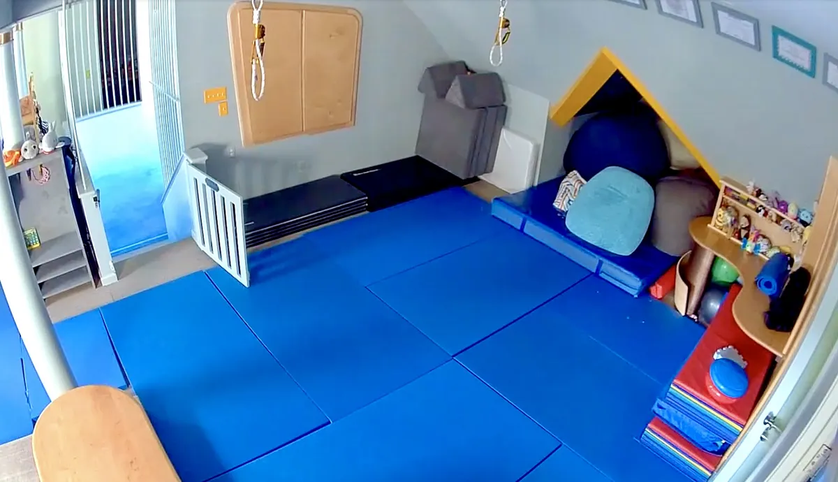 Joyous OT therapy playroom with blue floor mats and sensory equipment