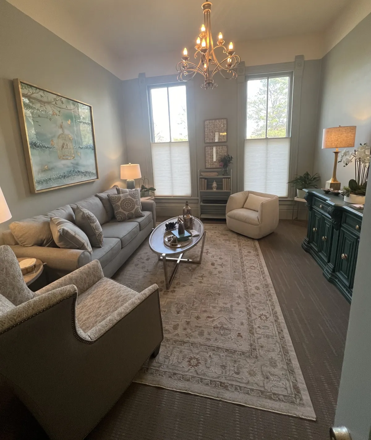 Attachment Services of Arkansas sitting room with chandelier and gray sofa