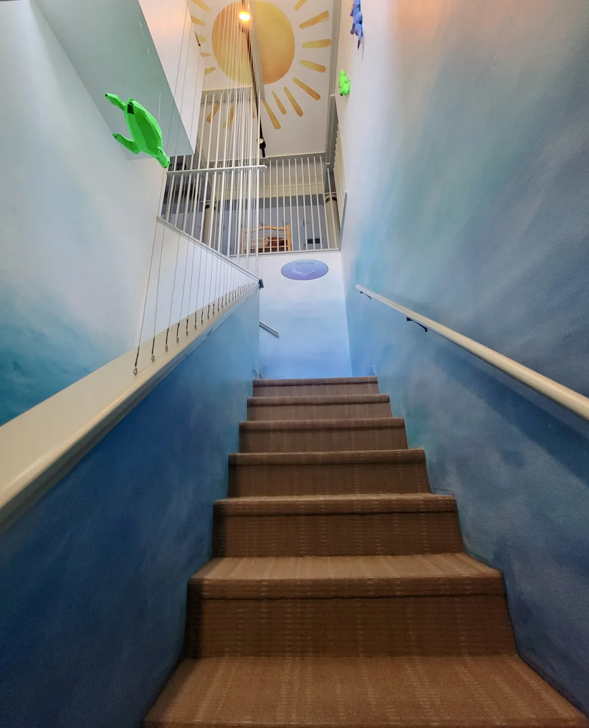Ocean-themed stairway leading up to the Joyous OT space