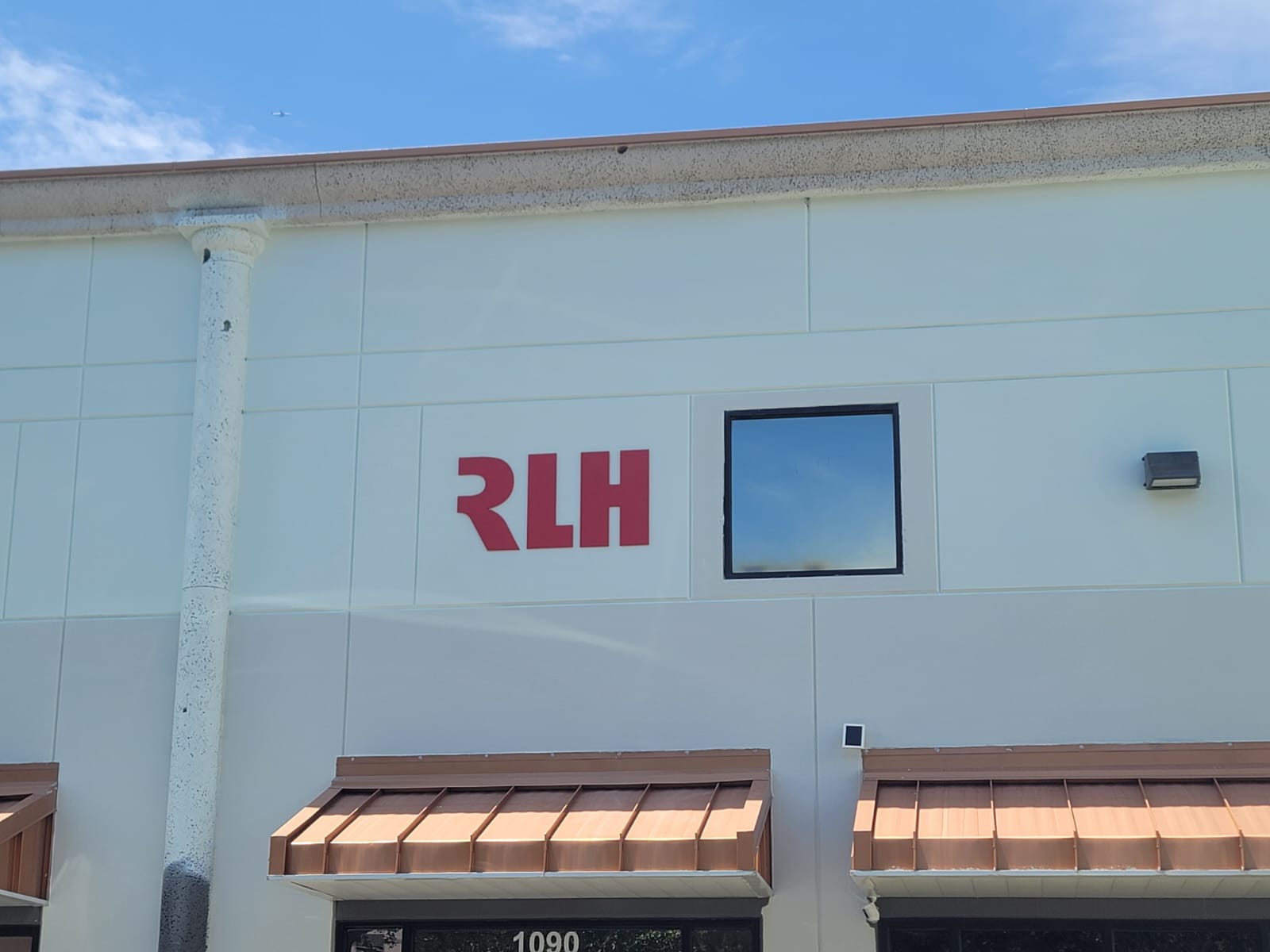 Interior living room refresh with soft neutral walls and crisp white trim, natural sunlight from windows.