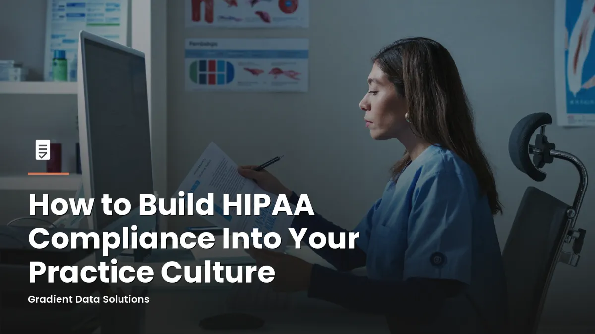 Practice administrator reviewing HIPAA compliance documents at a medical office workstation