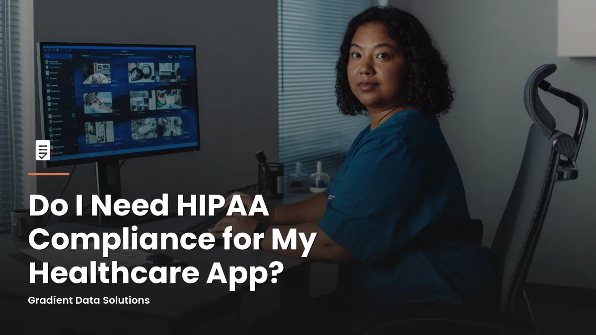 Healthcare practice administrator at a medical office workstation reviewing patient compliance records