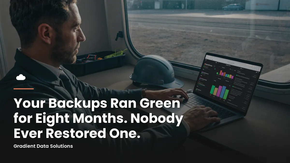 Construction project manager checking a backup status dashboard in a job-site trailer
