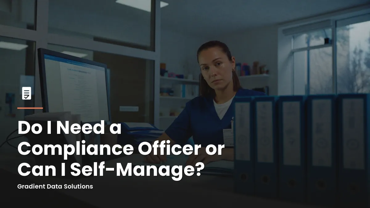 Practice administrator reviewing compliance documentation at a medical office workstation