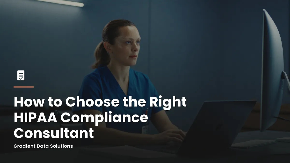 Practice administrator reviewing HIPAA compliance documents at a medical office workstation