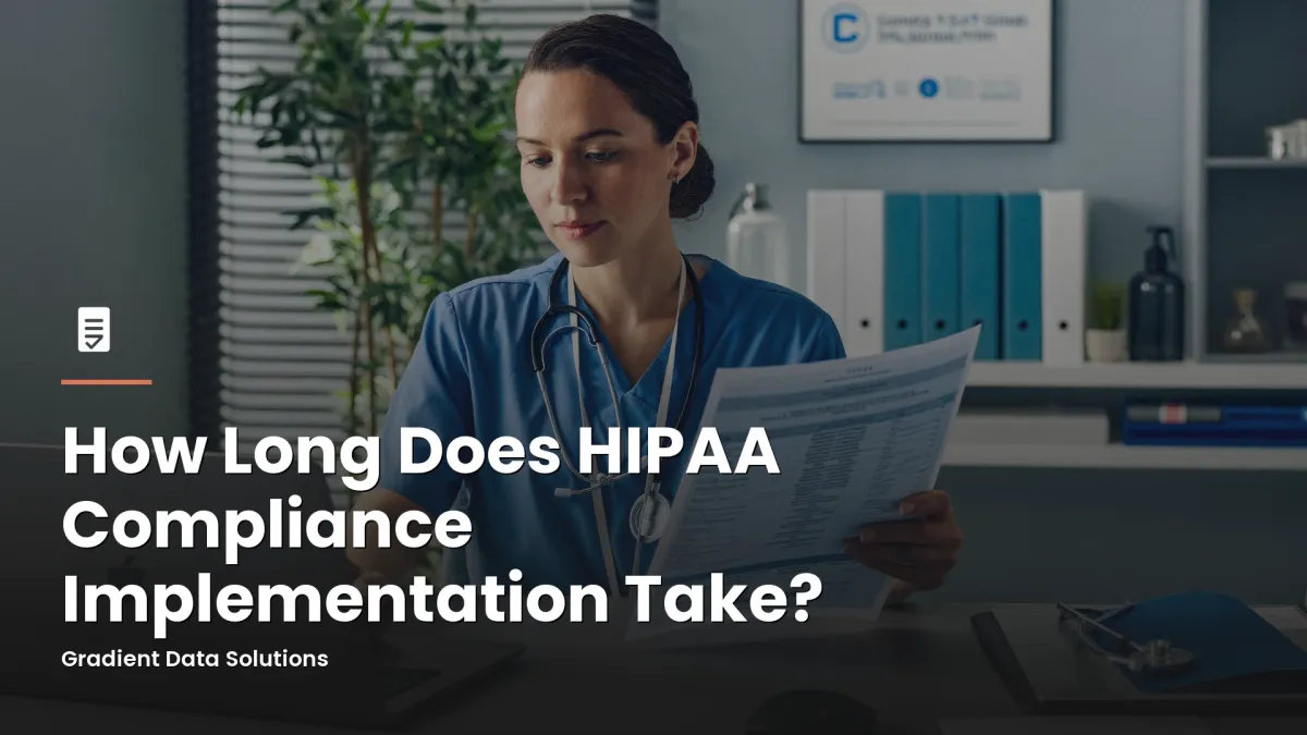 Practice administrator reviewing HIPAA compliance documentation at a medical office workstation
