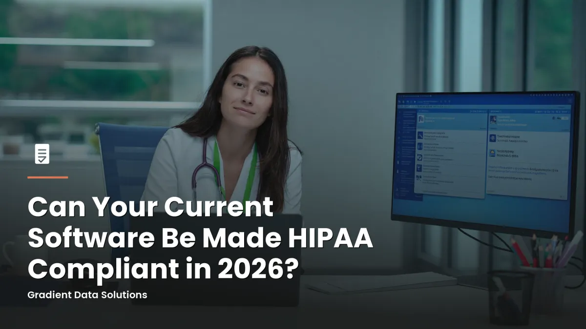Practice administrator reviewing HIPAA compliance documents at a medical office workstation