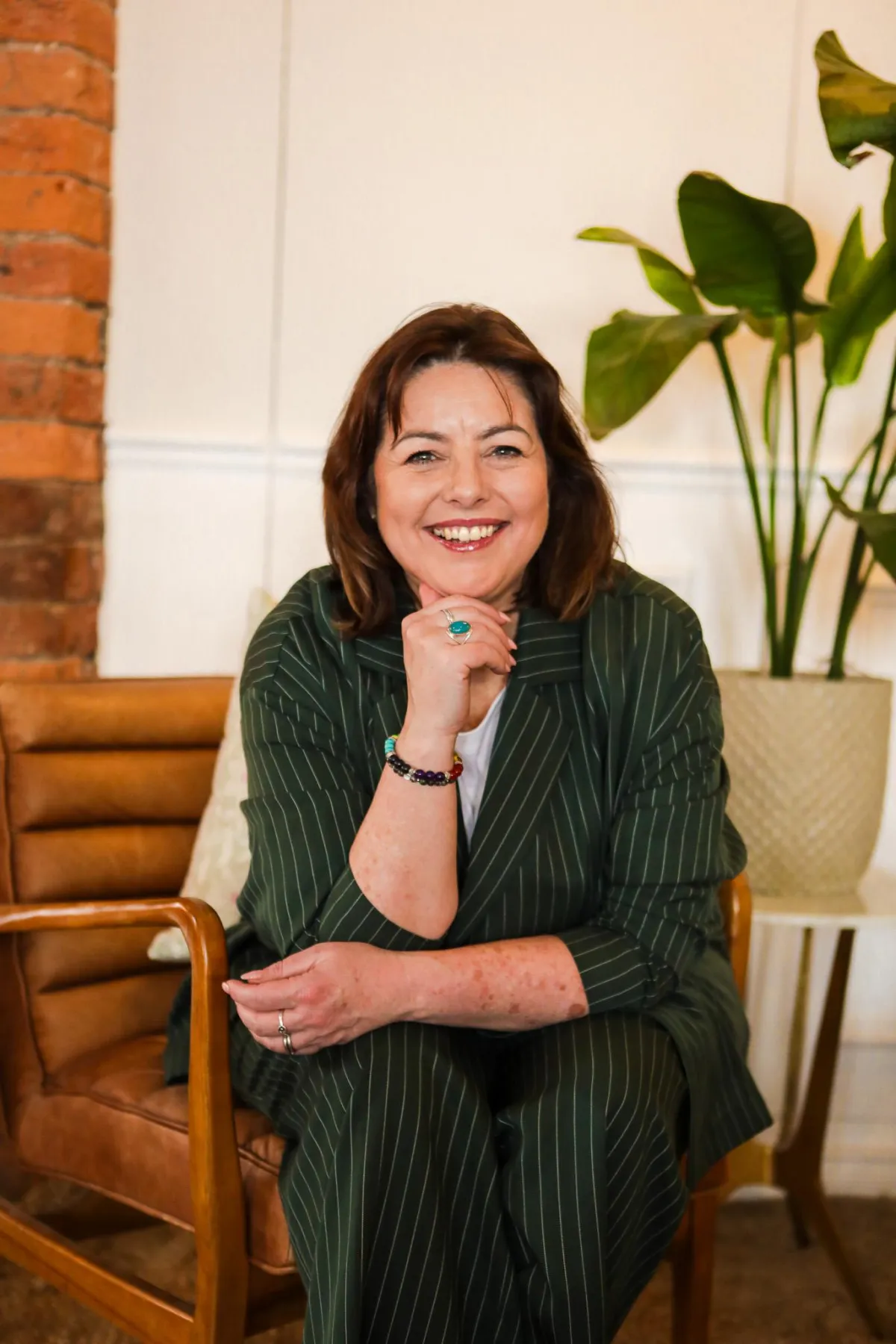 Friendly midlife wellbeing coach smiling in a calm, modern space