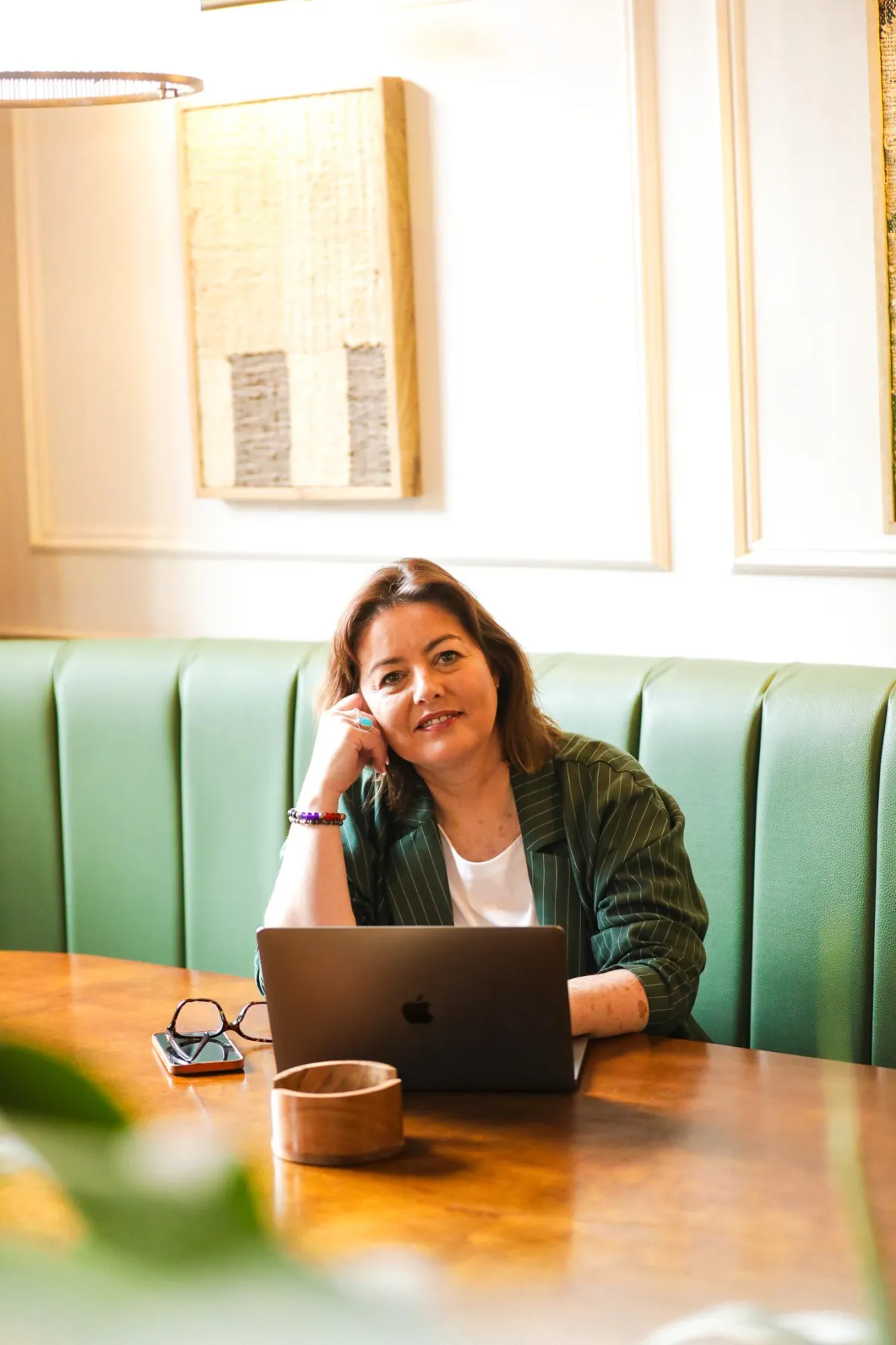 Calm modern midlife woman taking a reflective wellbeing quiz on a tablet with a mug of tea nearby