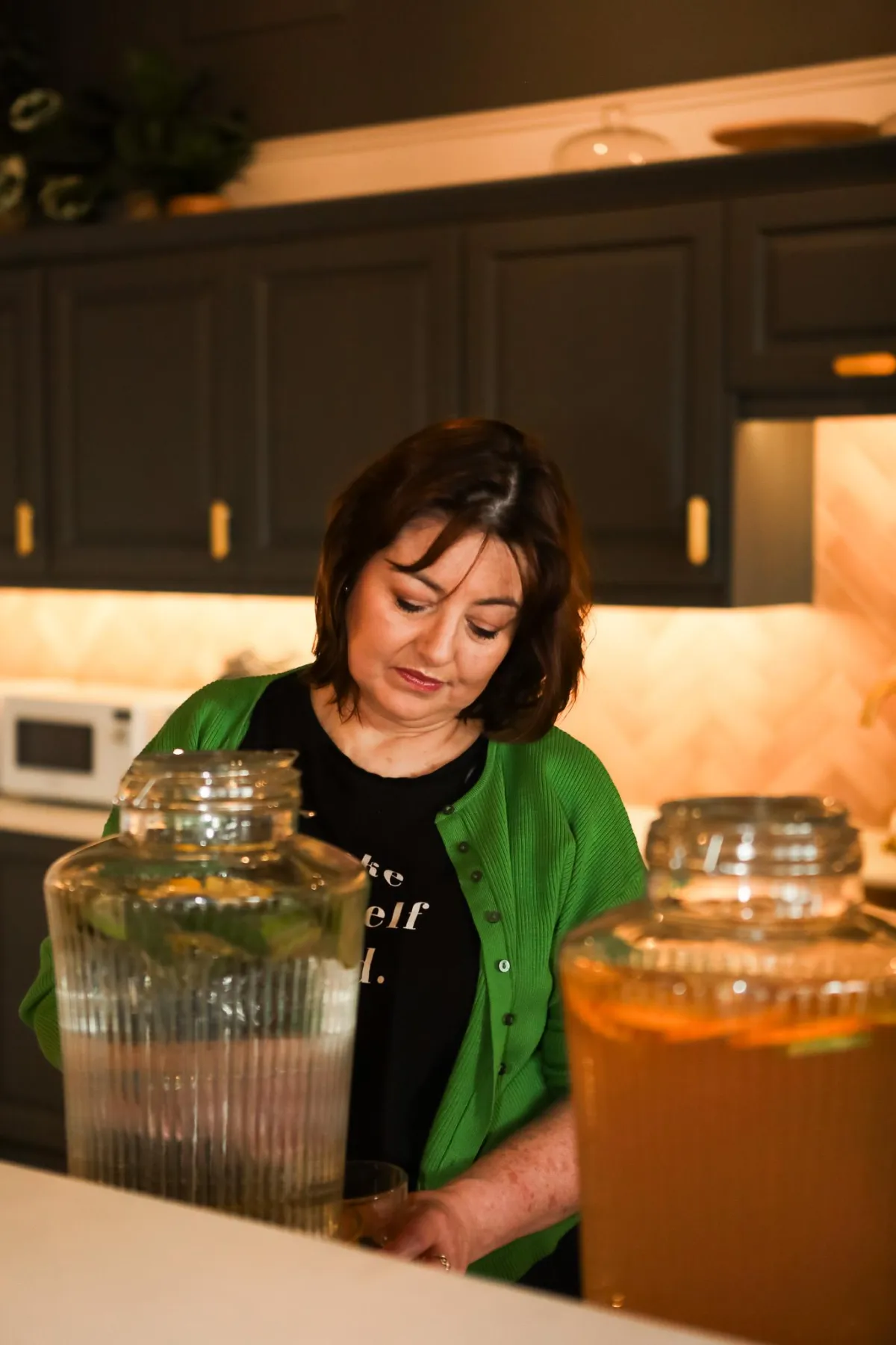 Welcome page of ME FIRST workbook; green plants; pen; green apple