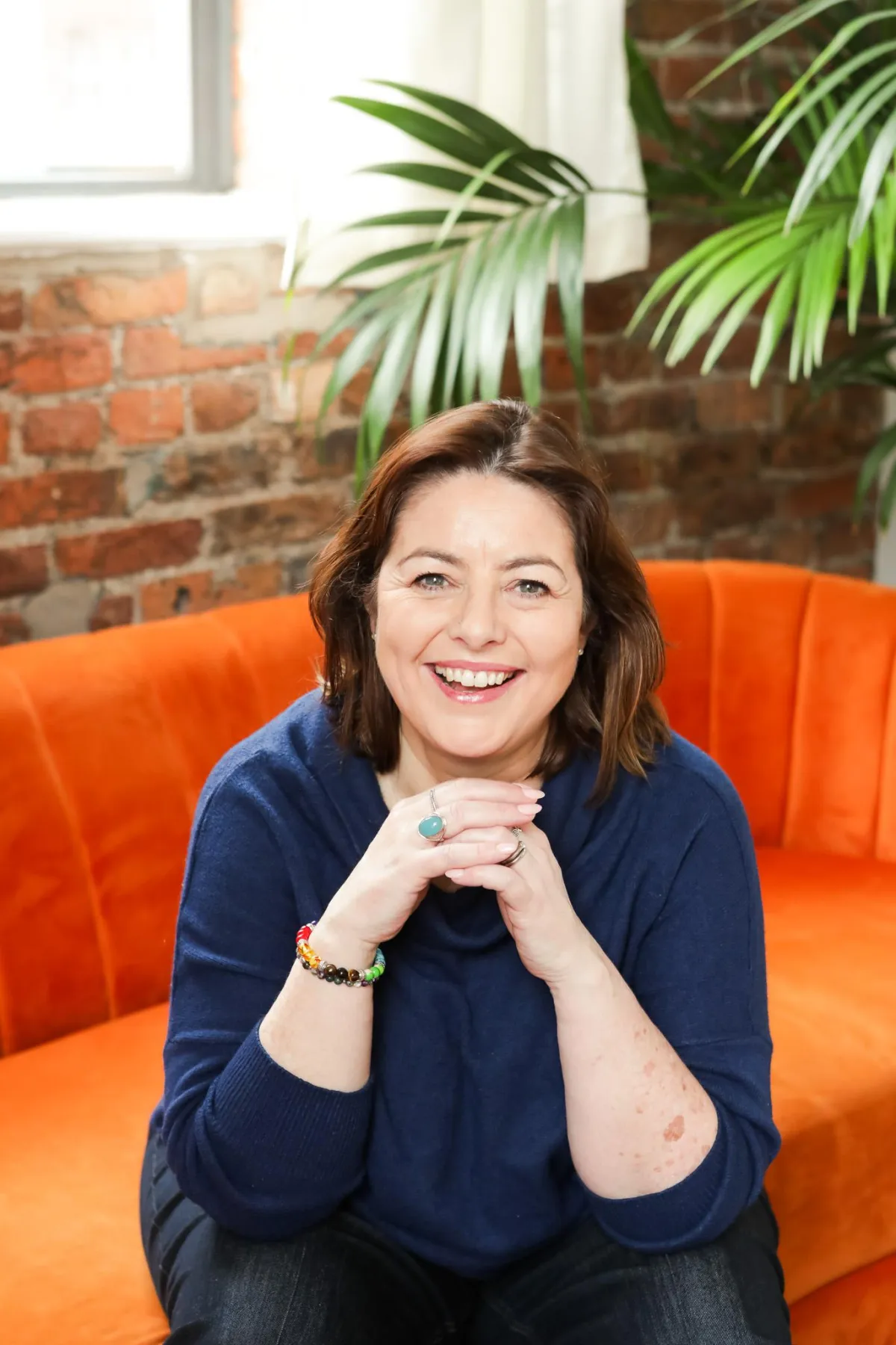 Elissa wearing blue and smiling straight at the camera