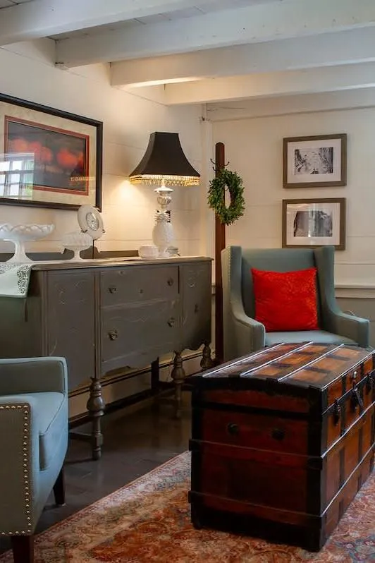interior image of cabin home with two chairs and a chest table